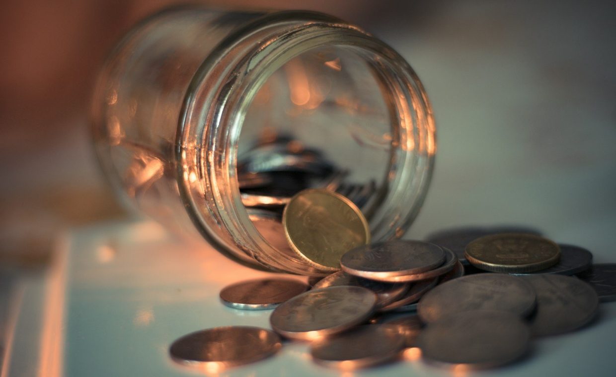 clear glass jar with coins