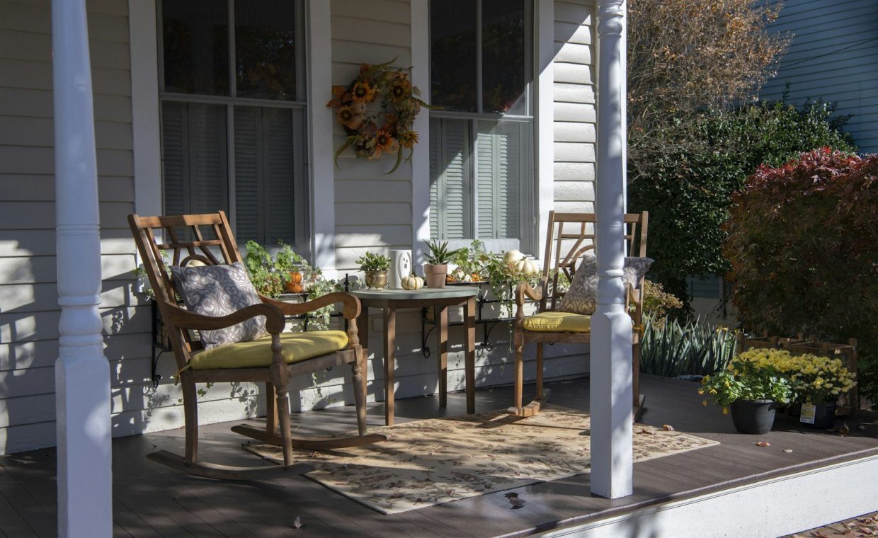 brown wooden chairs and table near white wooden post