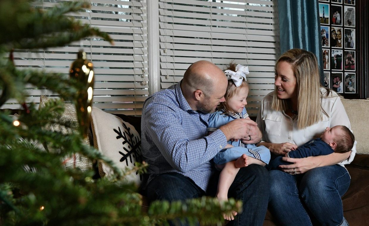 Family poses together for a christmas photo.